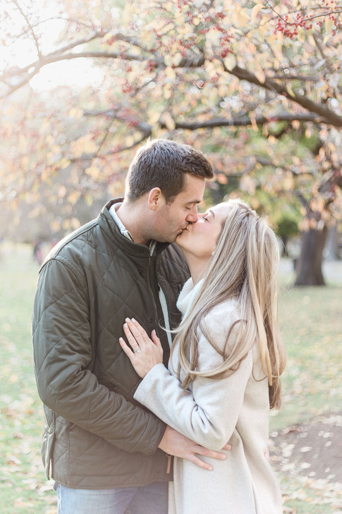 Engaged couple kiss in the BOston Public Garden during their engagement session