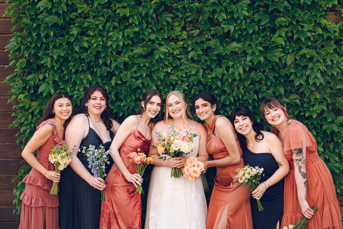 The bride and her wedding party share a laugh during portraits at The Joinery in Chicago
