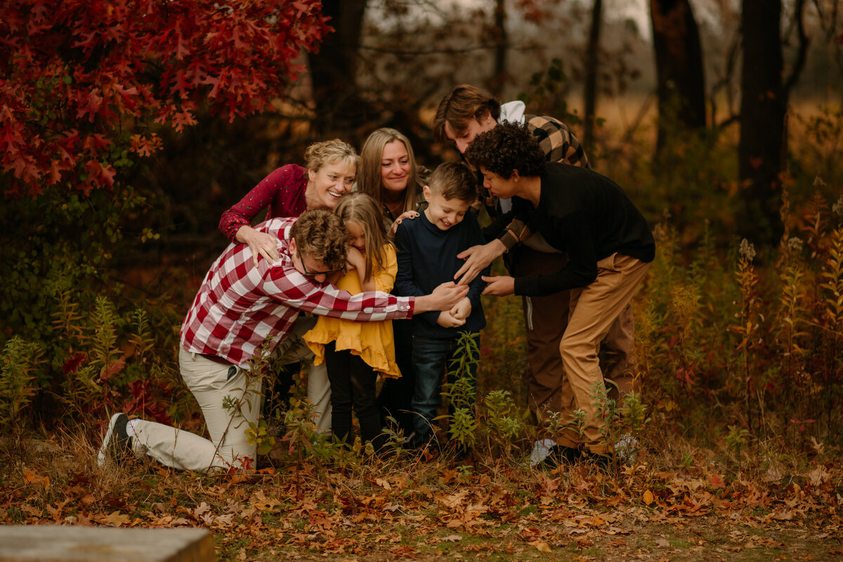 Capturing the warmth of family love amid the fall splendor. Shannon Kathleen Photography invites you to create lasting memories at Tamarack Nature Center. Book a session for timeless portraits.