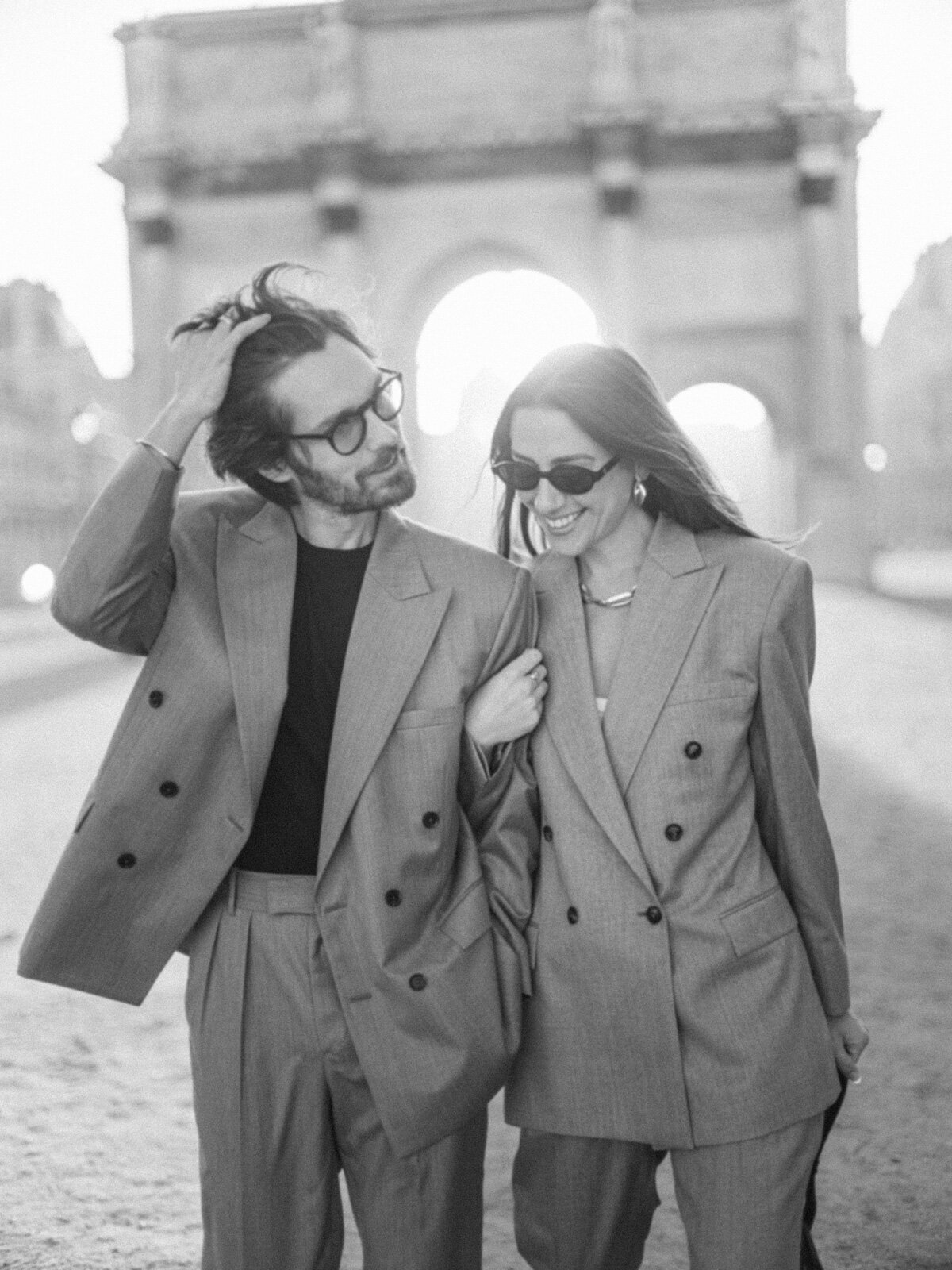 Engagement session at the Tuileries and Louvre in Paris, with a couple walking through the gardens under the morning light.