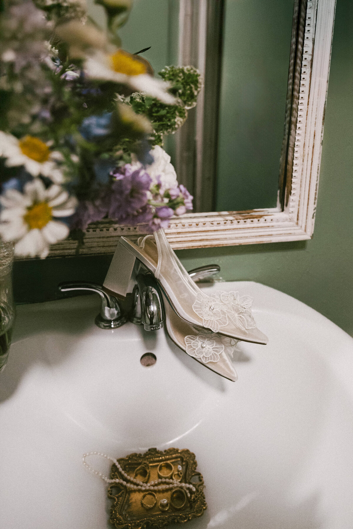 photo of brides wedding shoes posed in an editorial style at a austin wedding venue