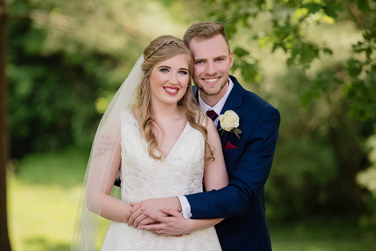 wedding couple holding each ohter