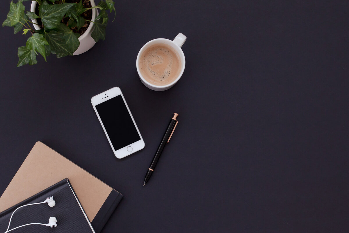 coffe, pen and phone on table