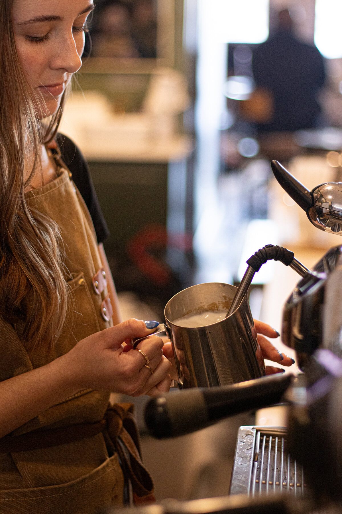 a barista steaming milk