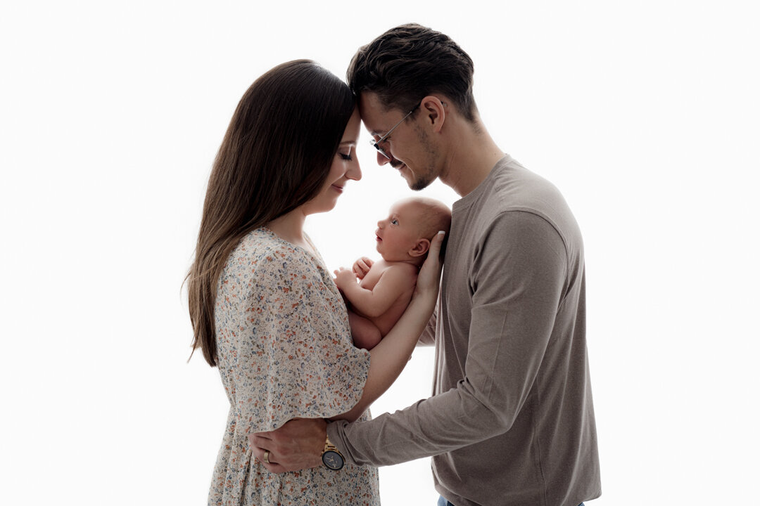 Grand Rapids Newborn Photography Mom and Dad Looking at Baby by For the Love of Photography