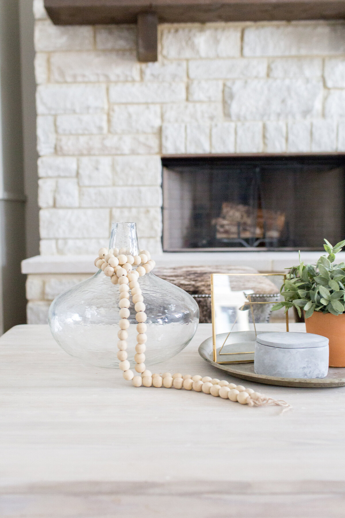 decor on table in front of stone fireplace