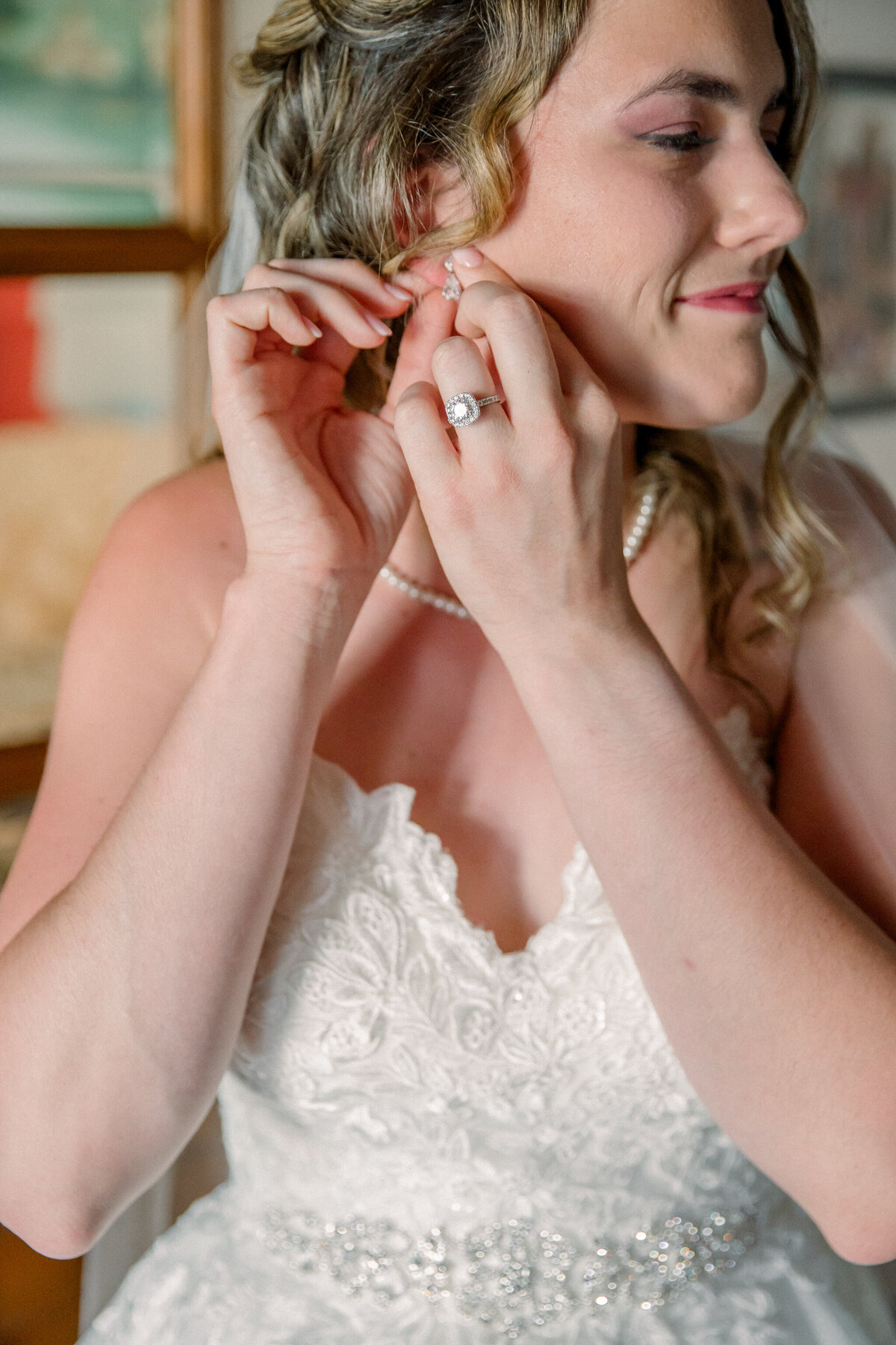 Destination Wedding in Spain | A bride adjusts her earrings before her wedding in Spain.