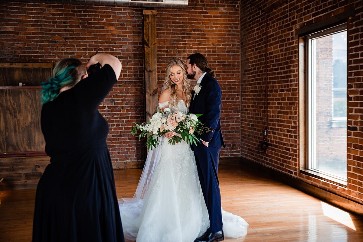 Photographer taking bridal photo inside Cannery Row Ballroom