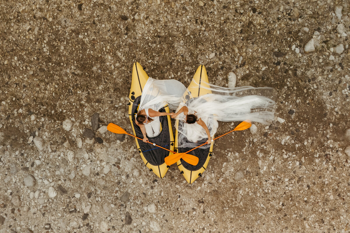 Aerial view of brides in yellow packraft in Soča Valley river elopement