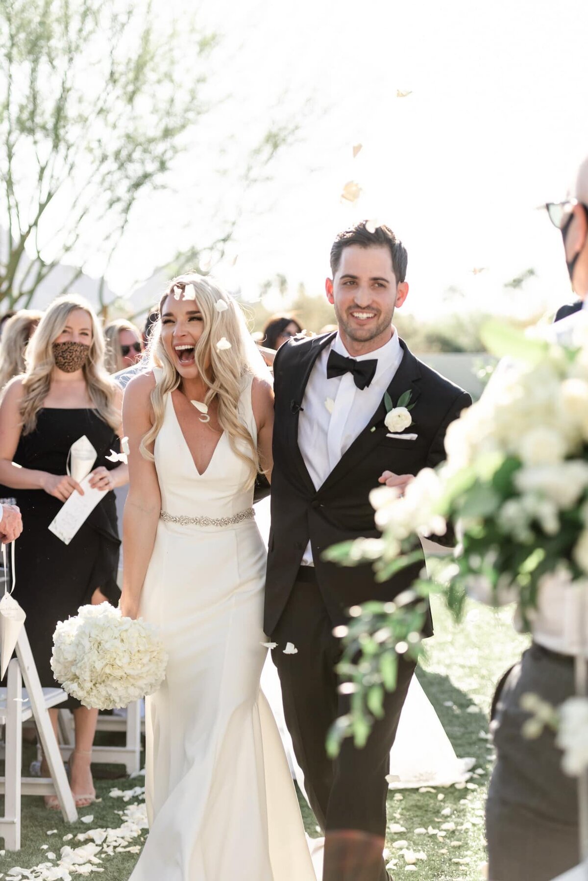 Bride excited as they walk down the recessional from ceremony at the Andaz Resort Scottsdale