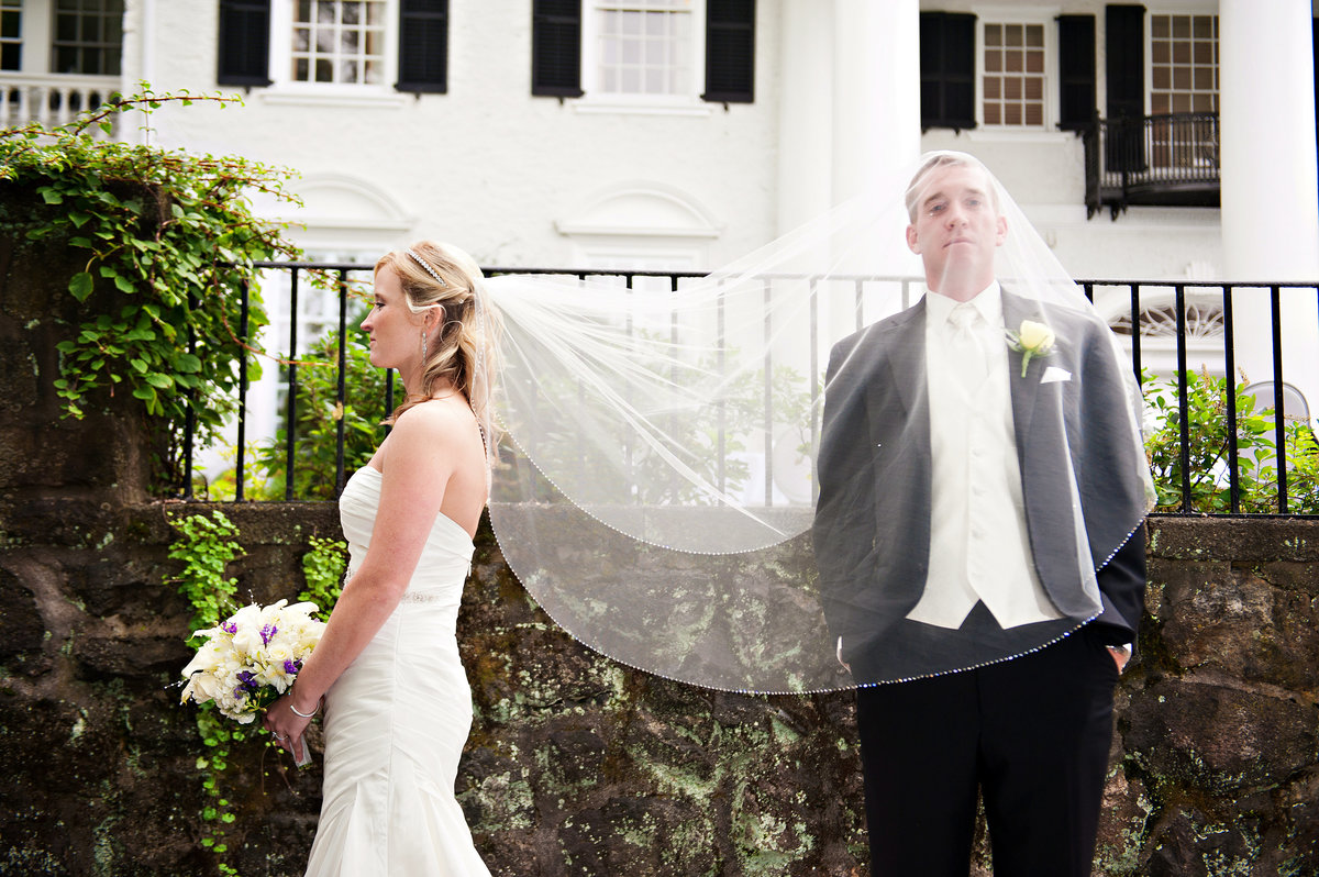 A groom gets a little weird under his bride's veil at their Radnor Valley Country Club Wedding.