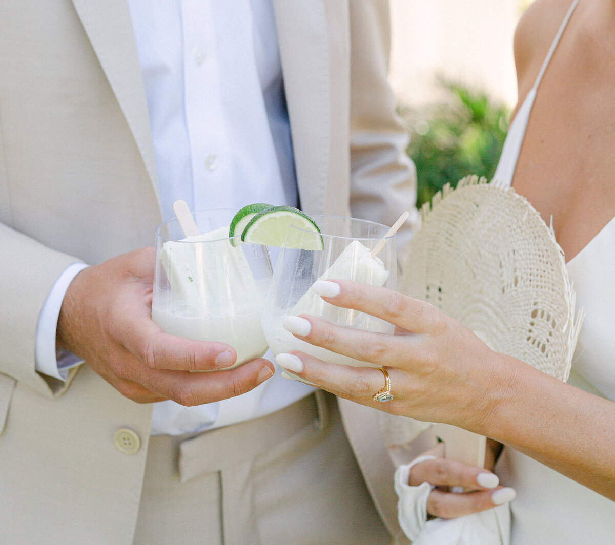 bride and groom holding popsicles in glasses at Rosemary beach wedding