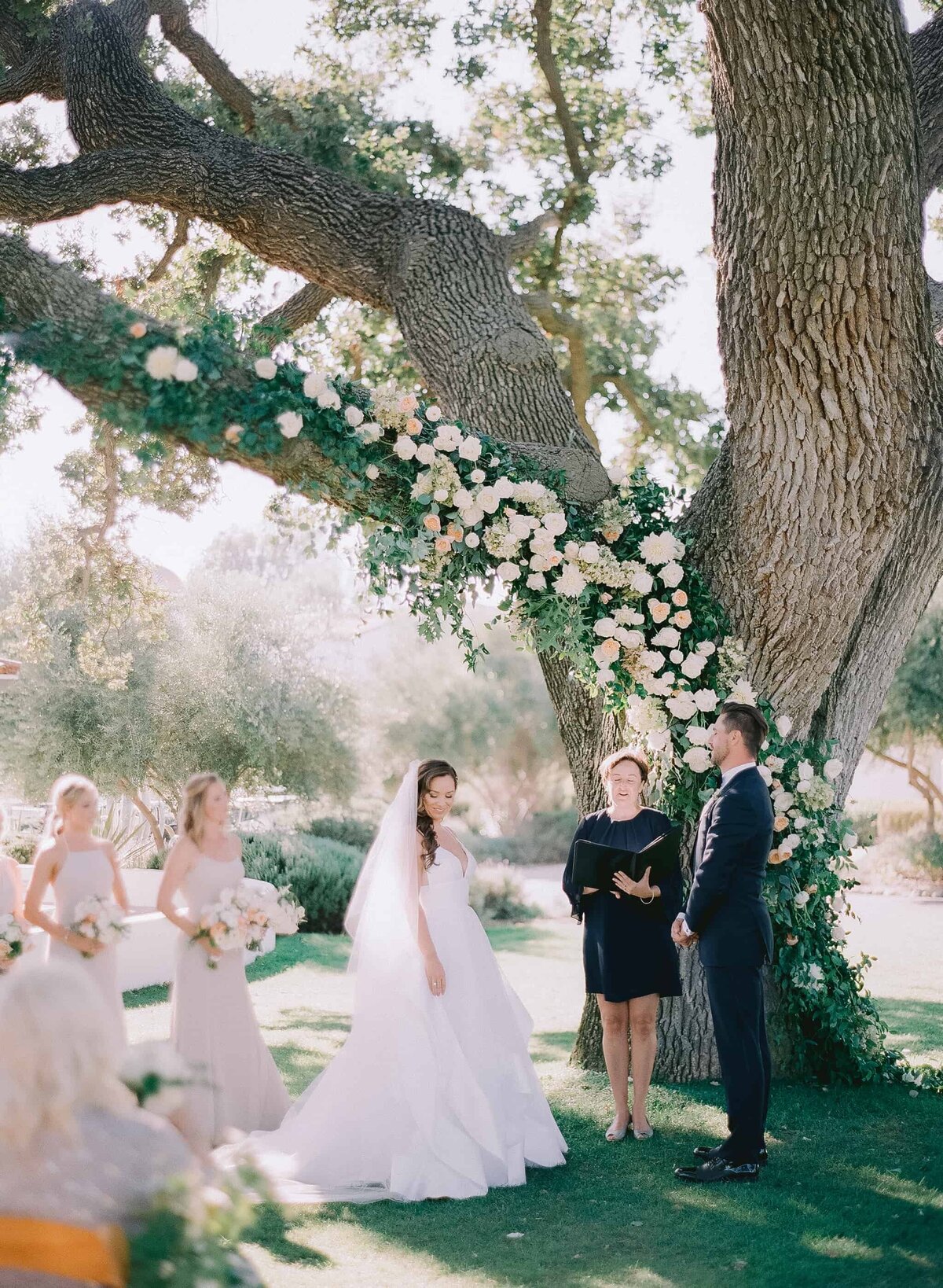 Bride and groom at the custom tree floral altar