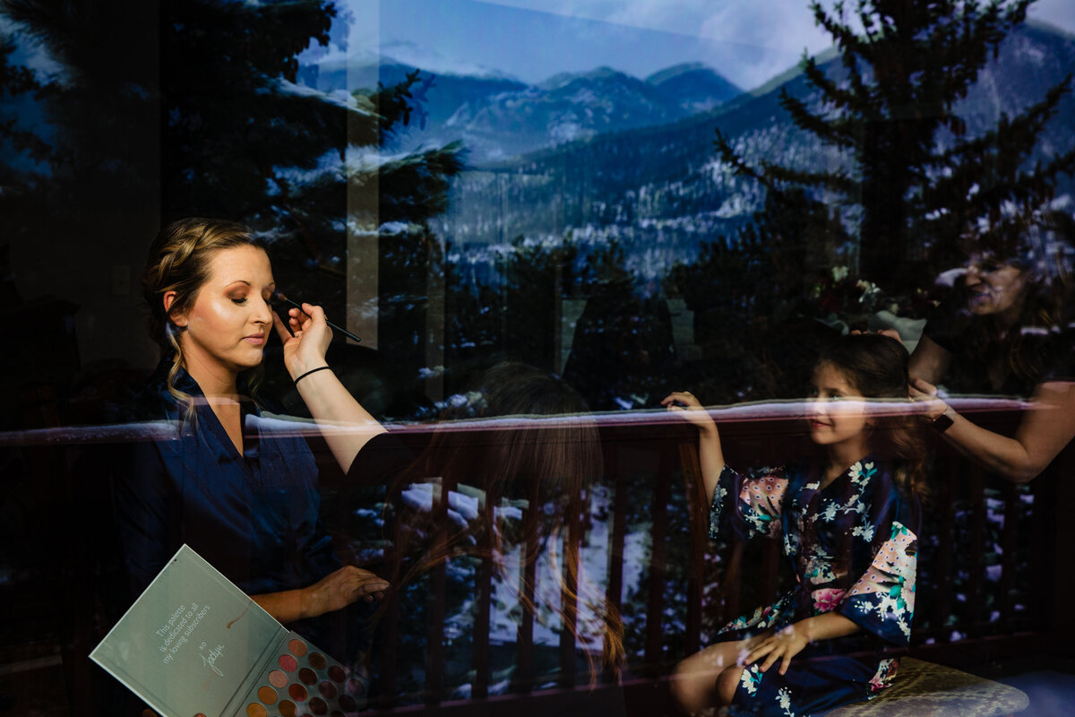 Bride gets makeup done before elopement in Rocky Mountain National Park