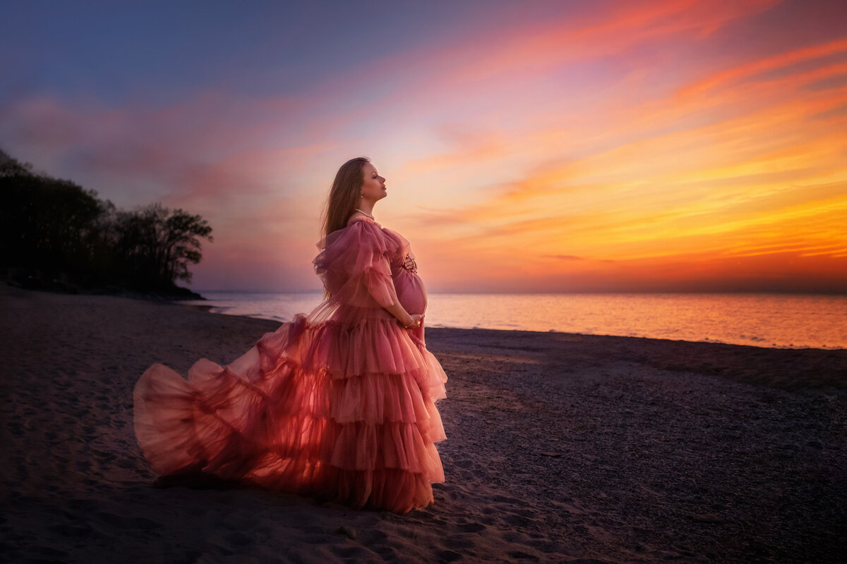 First time mom to be  posing at Indiana Dunes beach  with  beautiful pink  tulle dress with ruffles