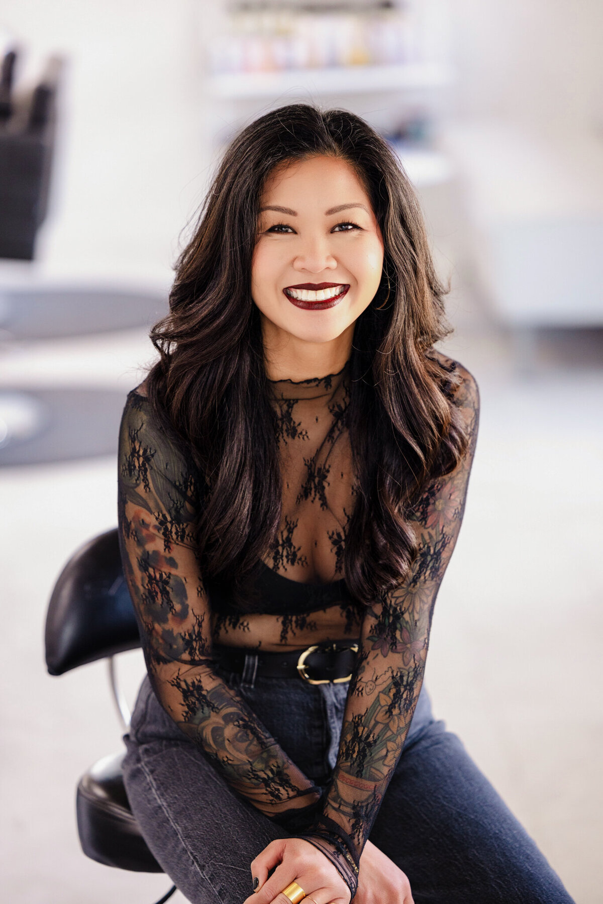 A clean and modern branding portrait, reflecting expertise and confidence in a high-end salon setting.
