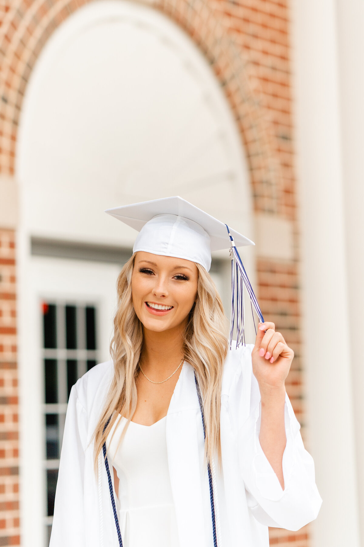 Kelley Hoagland is a Chattanooga senior photographer and North GA senior photographer taking cap and gown portraits at Gordon Lee High School location. Graduate posed holding tassel.