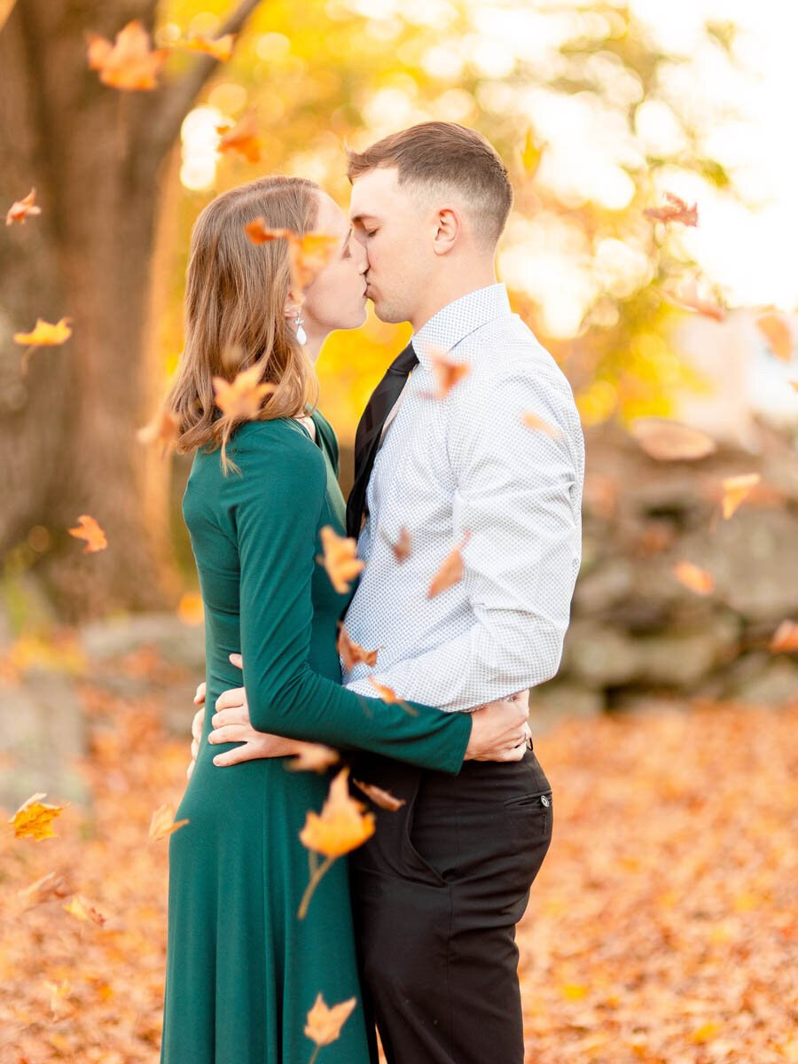 engaged-couple-falling-leaves
