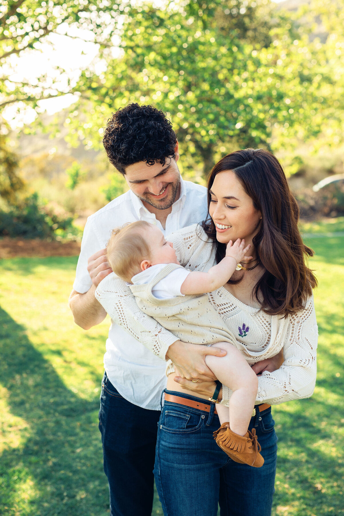 Family Portrait Photo Of Couple Carrying Their Baby In  Los Angeles