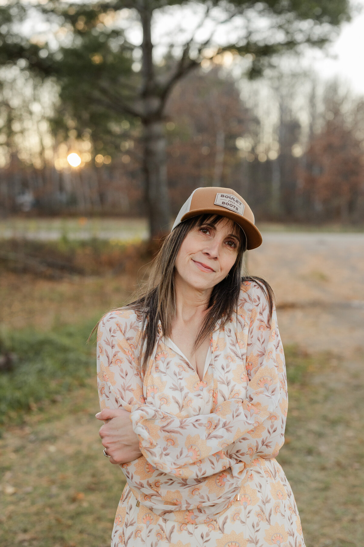 Close-up view of Julie with her sun dress and cap on, taken by solo branding photographer, Valerie Doucette