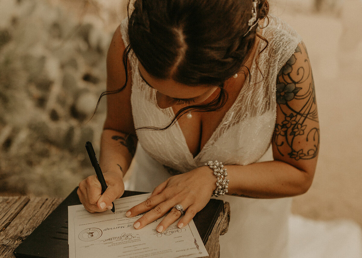 Bride writing on a paper