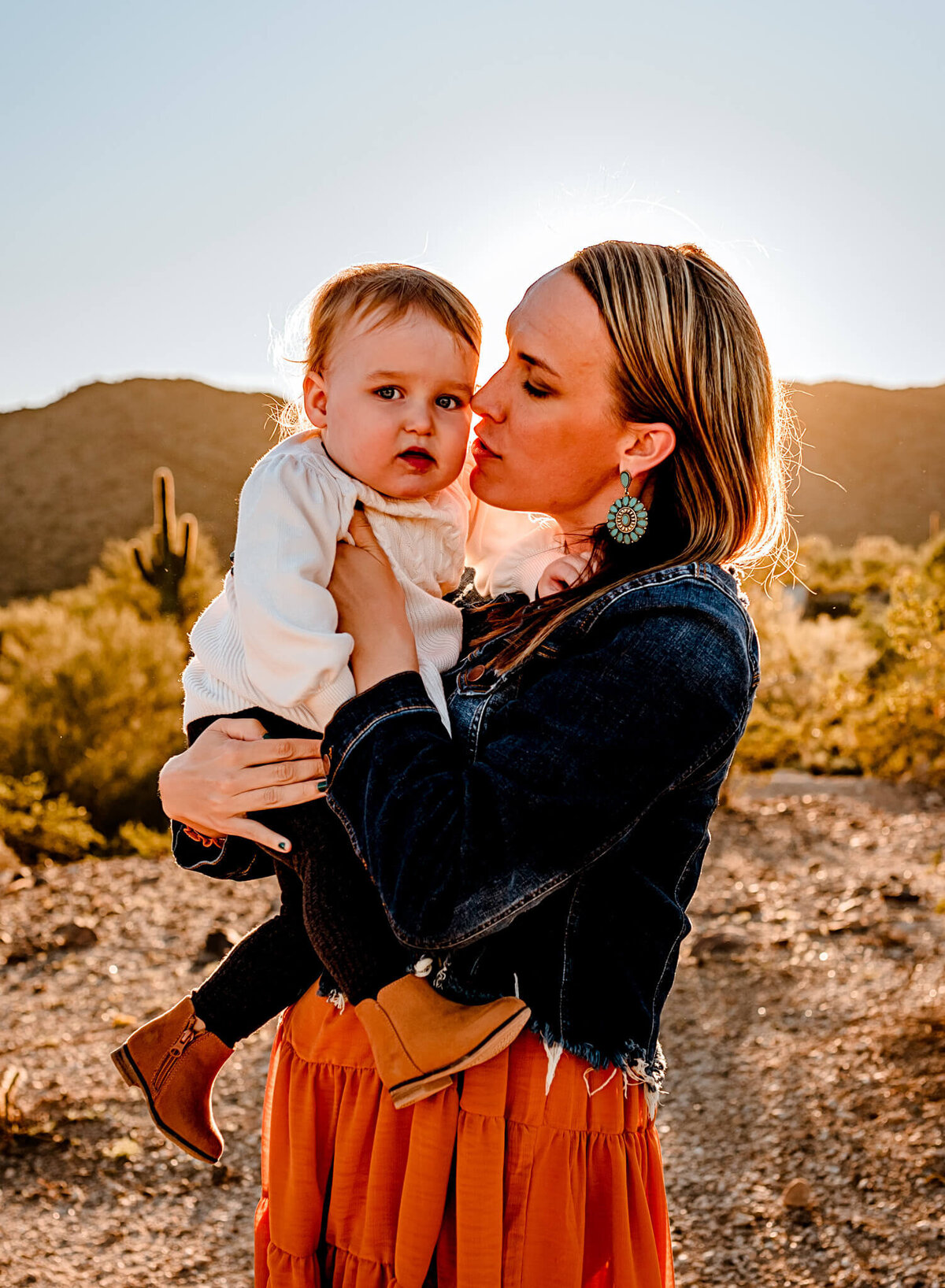 mom kissing daughter captured by AZ family photographer Cactus & Pine Photography LLC