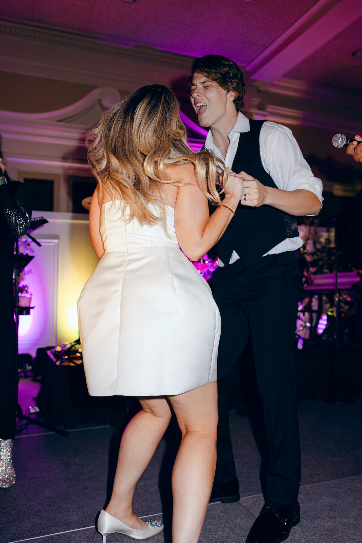 A wedding photo oft he bride and groom dancing during the wedding reception