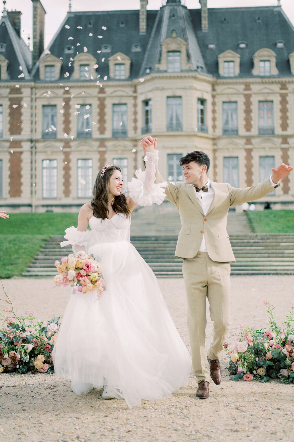 Celebrating after the bride and groom get married in front of chateaux de sceaux in France