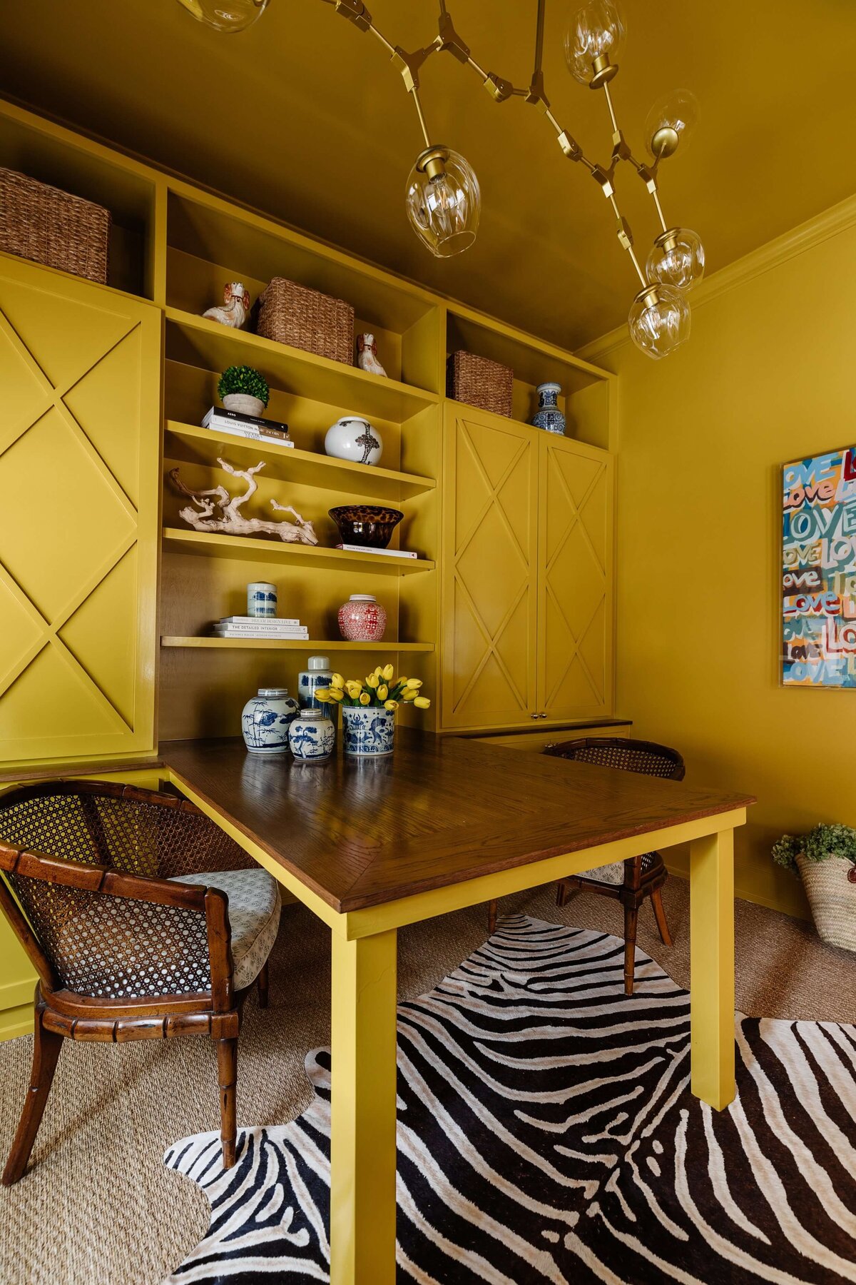 oyster creek studios home on the range yellow dining area with zebra print rug and shelves