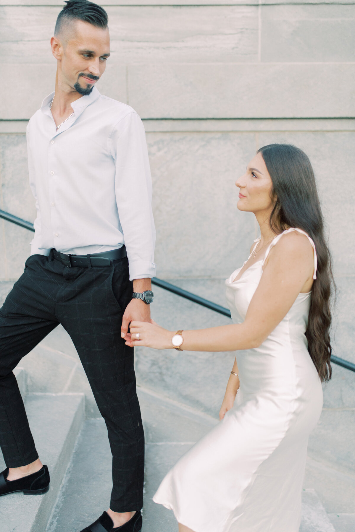 Groom lovingly guiding the bride up the stairs of Toronto’s RC Harris Water Treatment  Plant, a moment of support and connection