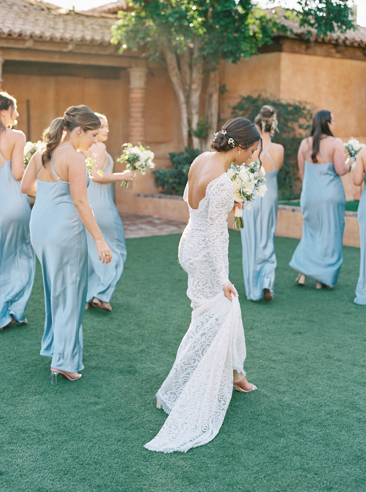 Fine art wedding photography capturing the bride and bridesmaids walking together before a romantic destination wedding ceremony.