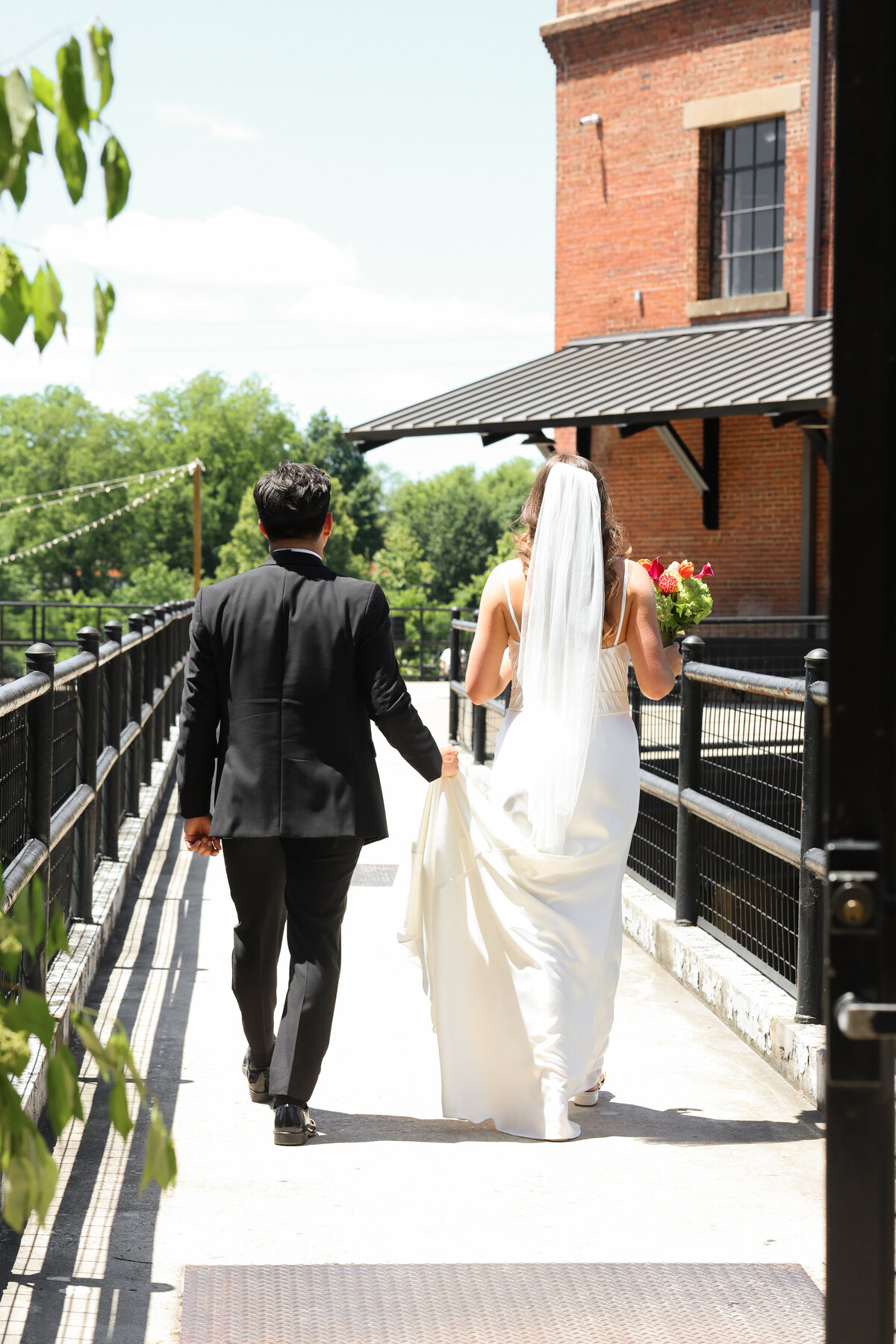 Groom-and-Bride-Walking-on-sunny-day-at-The-Powerhouse-Columbus-Georgia