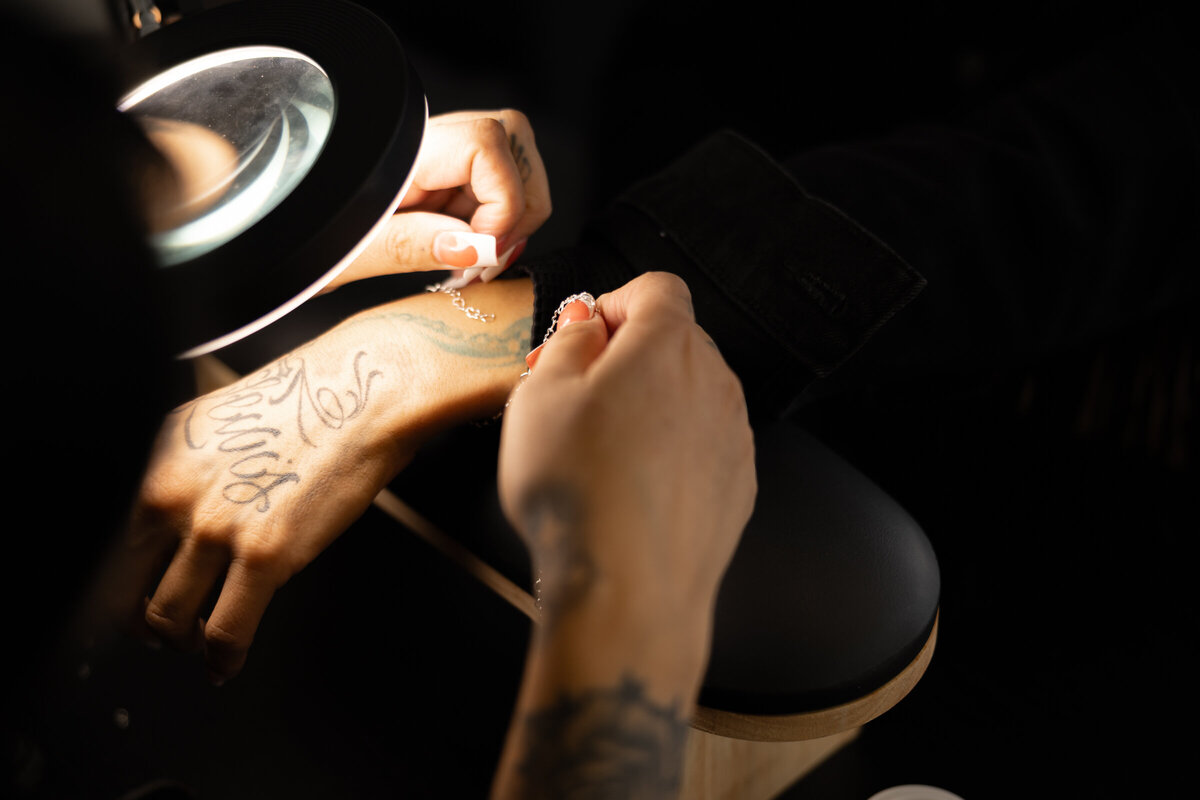 Beauty professional performing brow procedure on client lying in studio chair. Photograph by Yucaipa branding photographer Kaitlyn Dawn Photography.