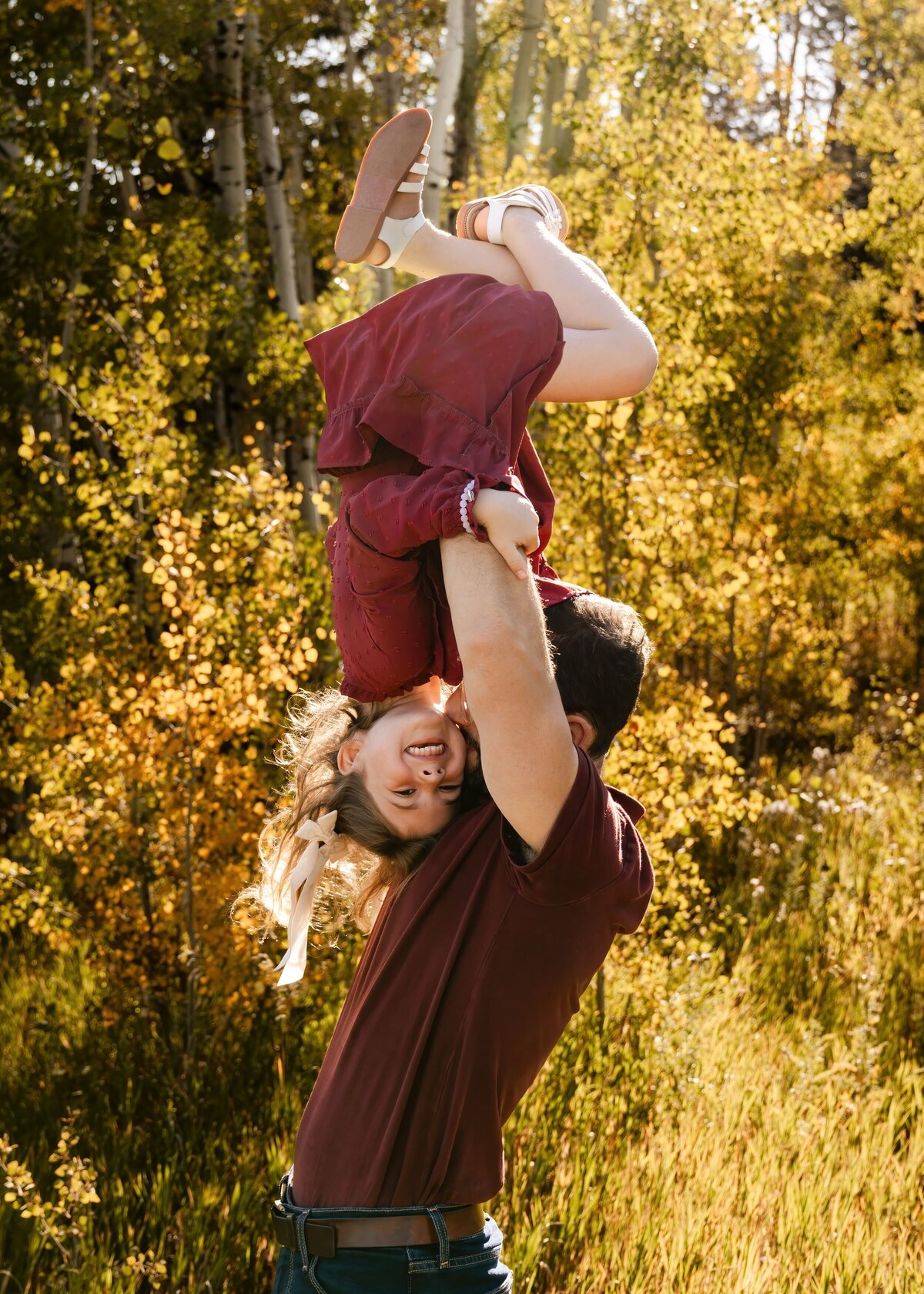 denver family photographer - dad holding daughter upside down