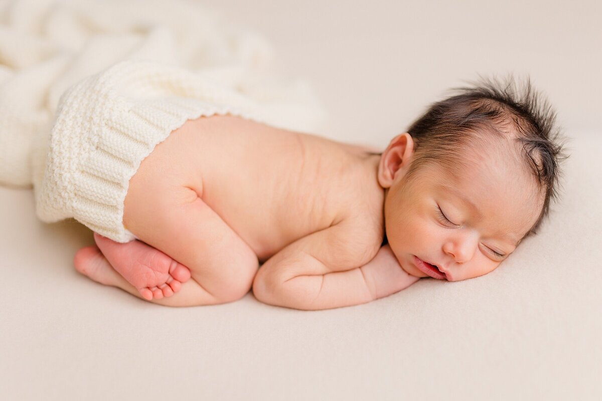 sleepy newborn baby girl cream