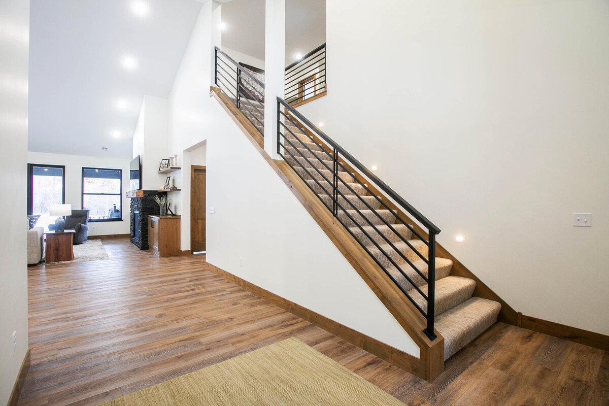 Light-filled entryway with wood flooring and neutral tones in a custom-built Elk River home