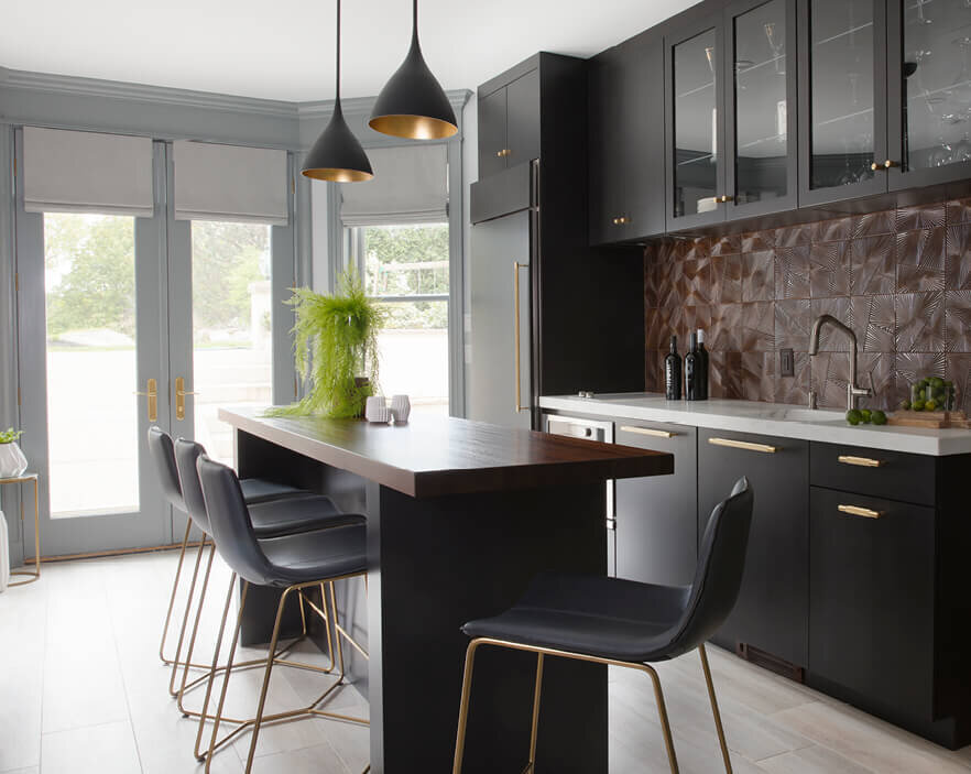 Boston Kitchen Designer creates a modern dark grey kitchen in a Westwood renovation with light floors, marble and wood counters, and Kelly Wearstler pendants.