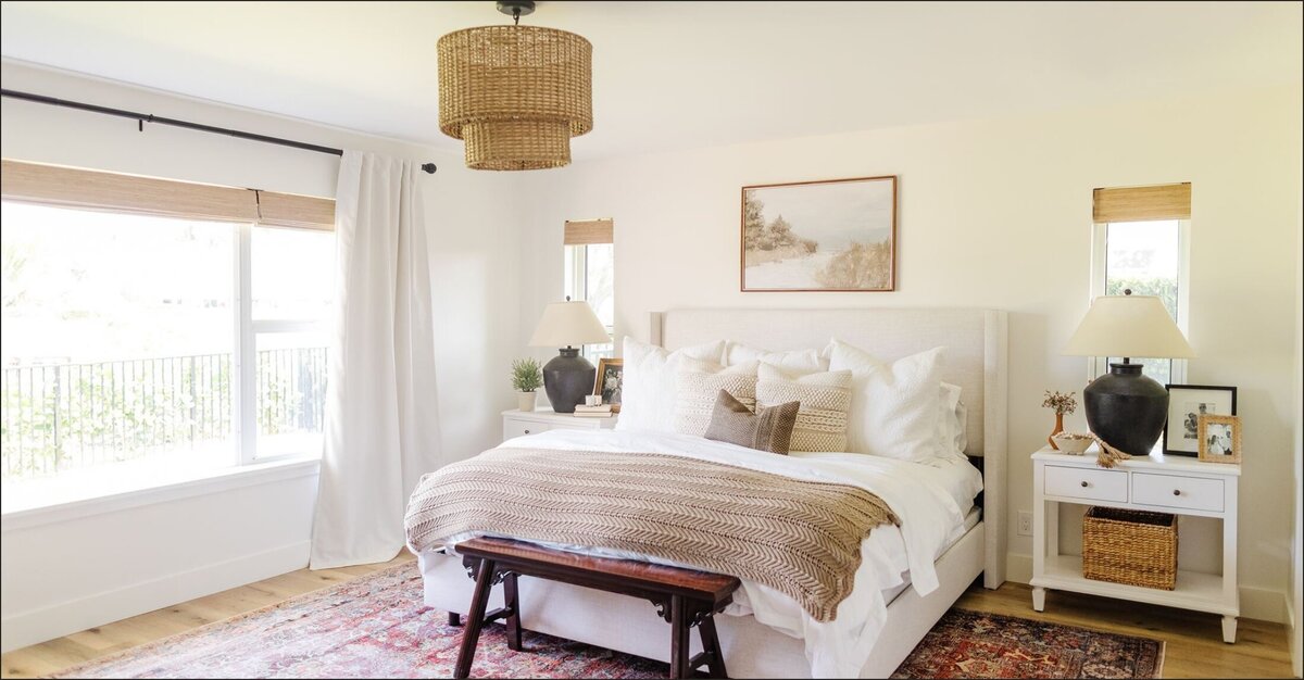 Bedroom with white comforter and wooden accents