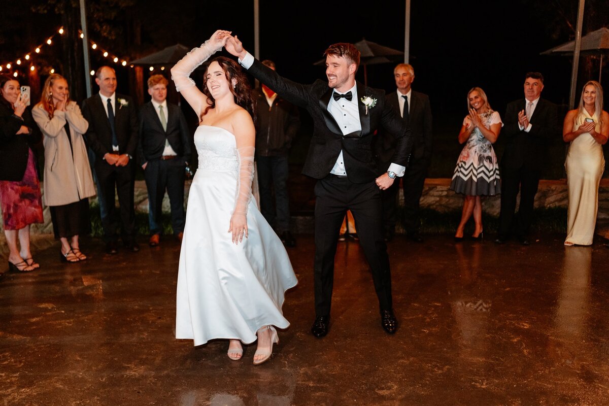 A heartwarming moment captured: a couple swaying together on the dance floor at their wedding reception, enveloped in love and joy.