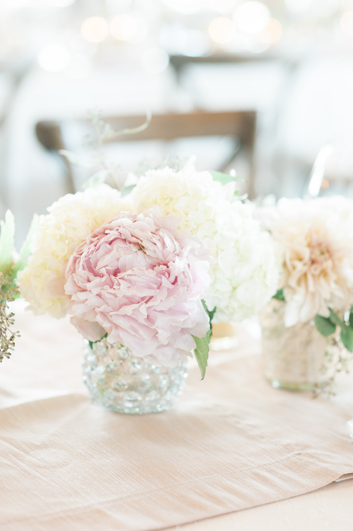 blush and white flowers on wedding table at ponzi