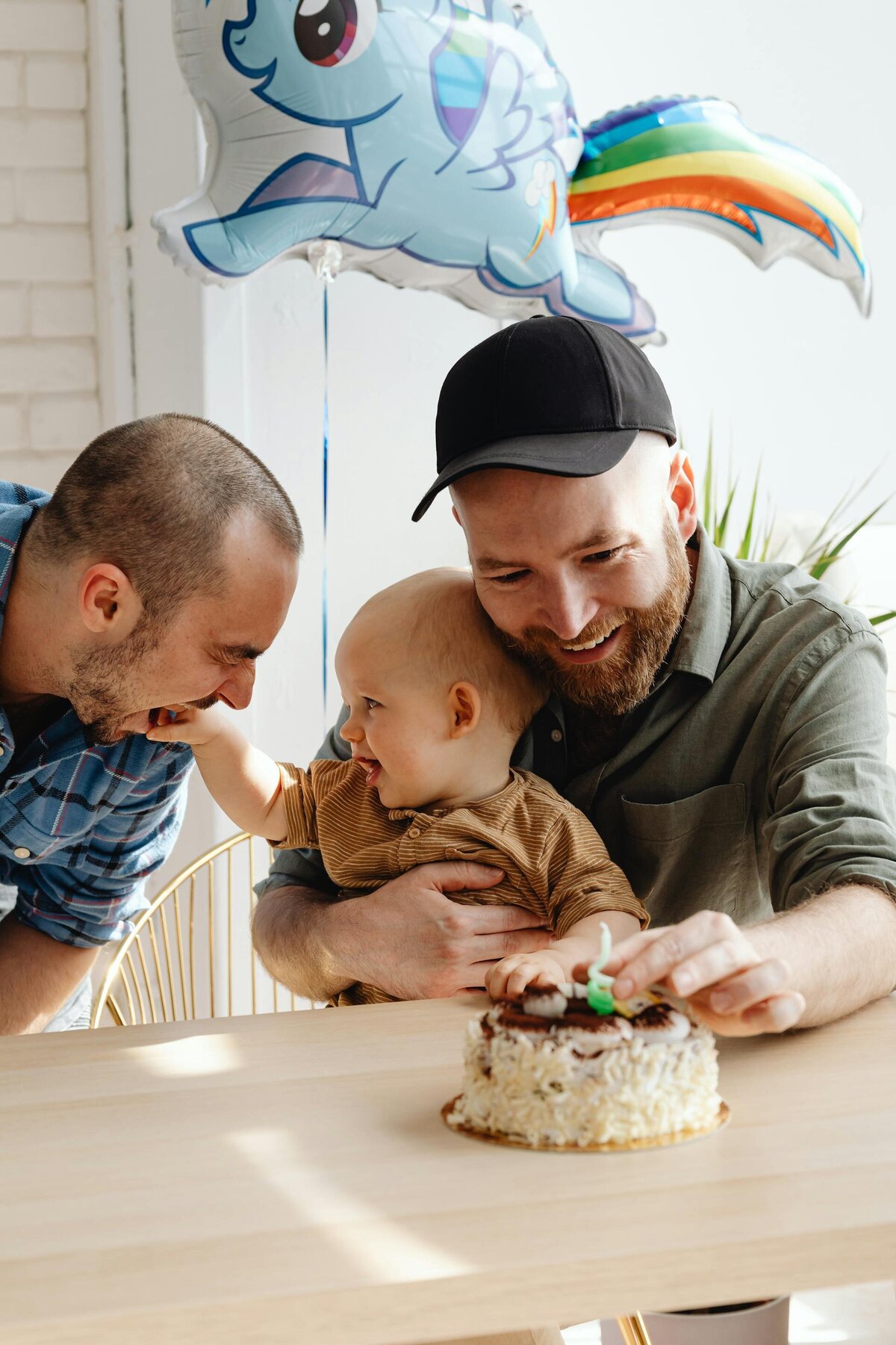 Two Dads with Kid Celebrating Birthday