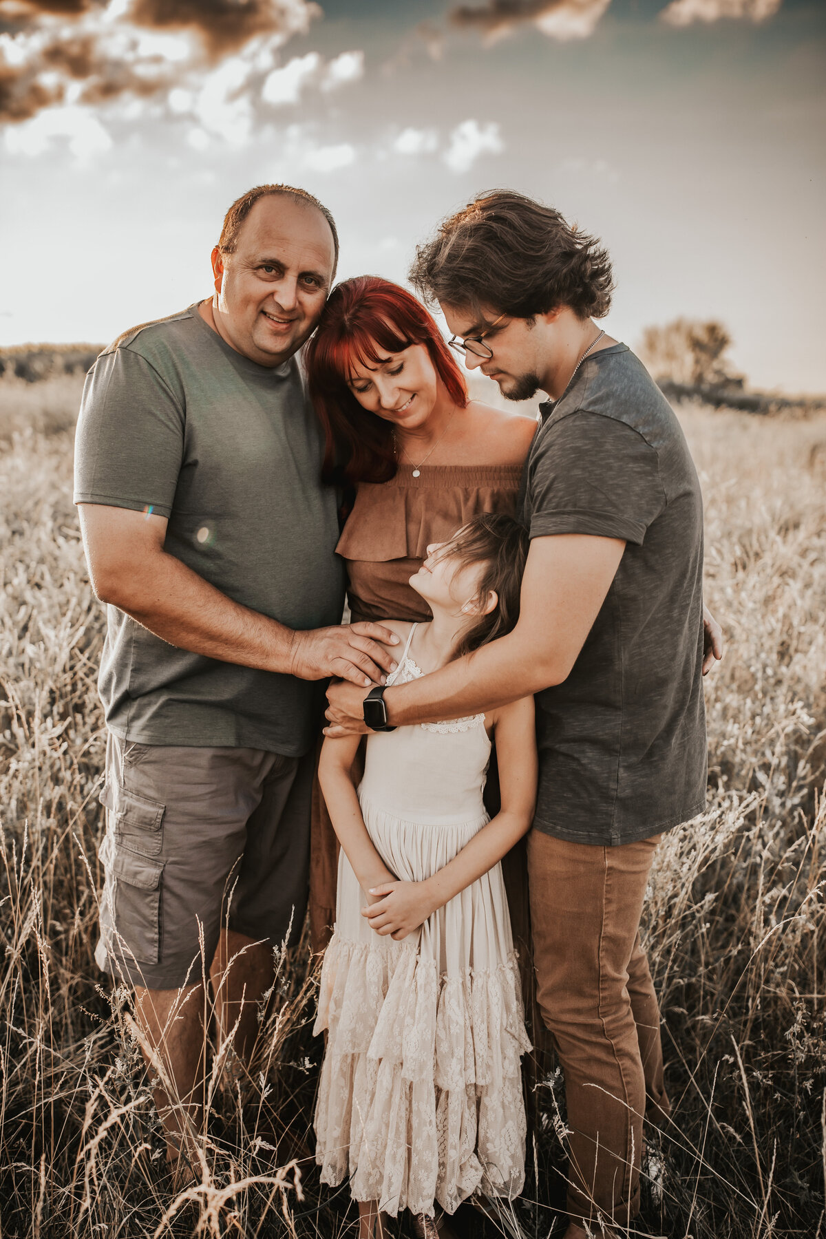 whole family is hugging and looking at each other