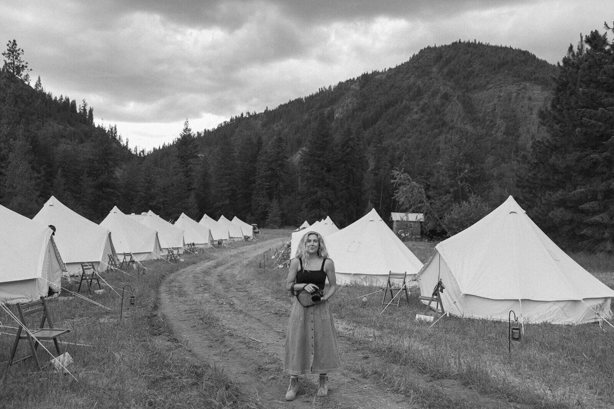 Minneapolis photographer stands among tents in festival style wedding