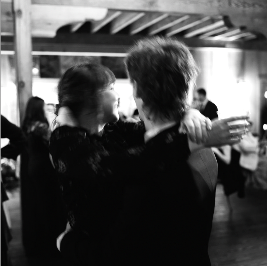 Black and white photo of a couple embracing on the dancefloor, captured in a candid love wedding photography style — Carmel wedding photography by Kate Winters Photography.