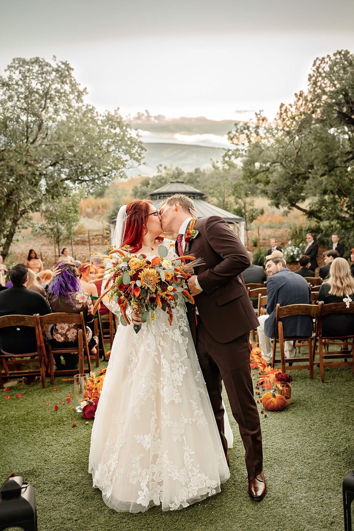 bride and groom kissing after they just got married