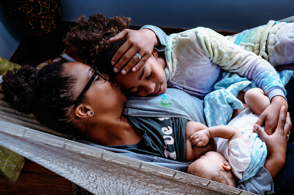 Mom and children cuddling in hammock