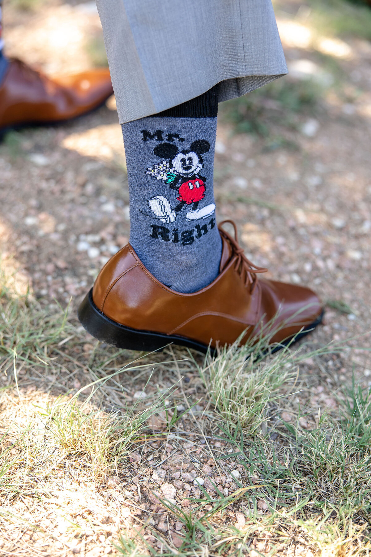 mickey mouse mr right sock under gray pant and brown shoe at Morgan Creek Barn wedding