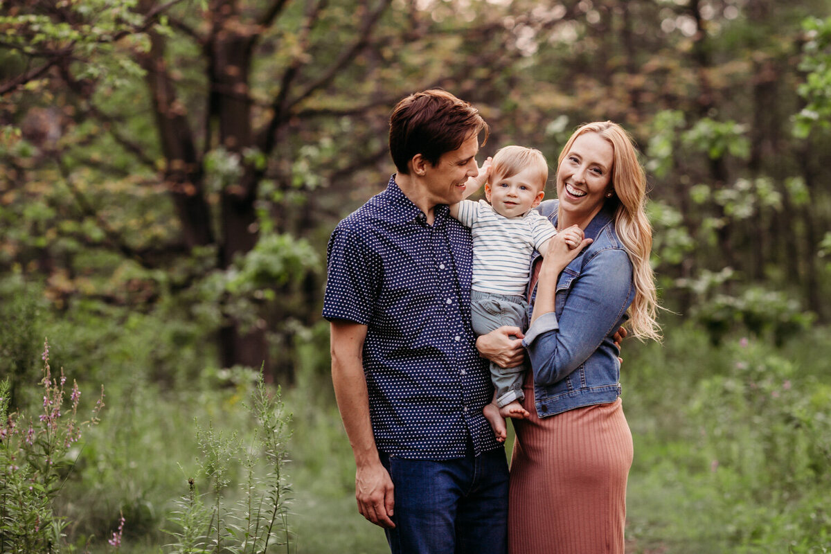 family of 3 smiling during family photography session in Toronto