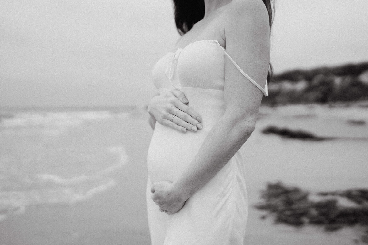 couple shoot for maternity session during golden hour Oregon coast beach wedding/elopement - photographed by The Storytellers