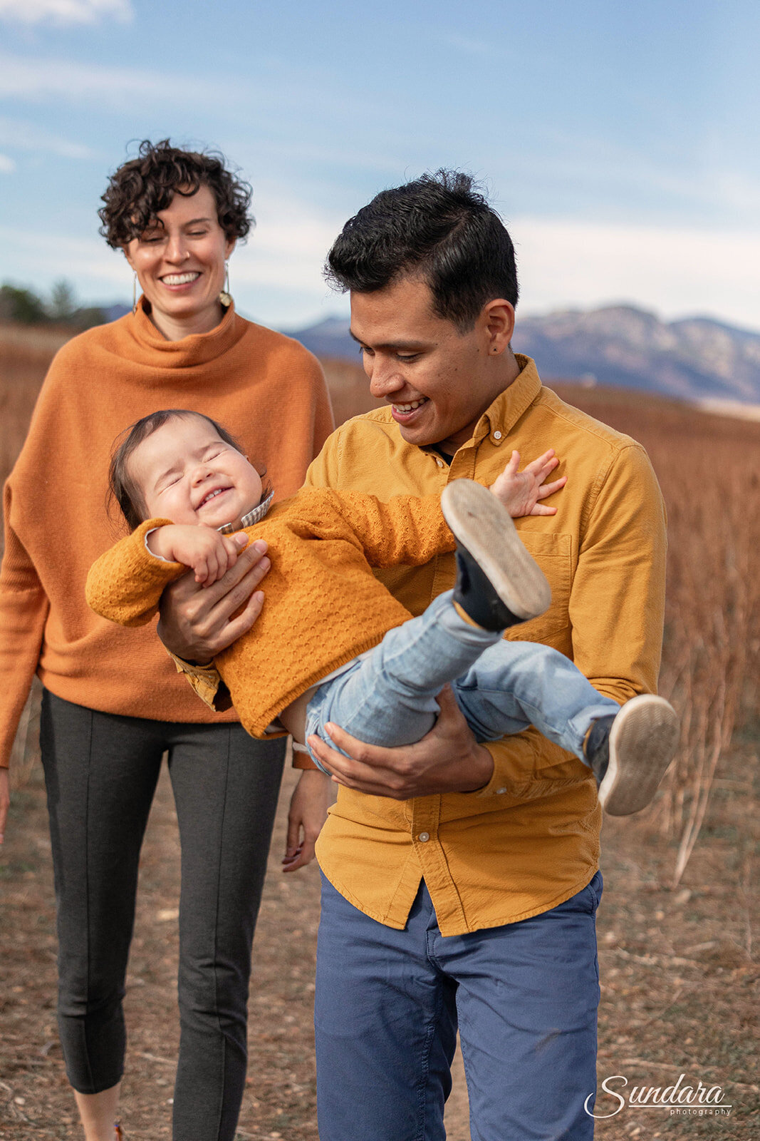 family laughing with baby in denver colorado